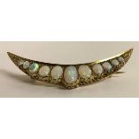 An 18ct gold crescent brooch set with eleven graduated fine opals, total weight of brooch 10g