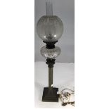 An Edwardian oil lamp with etched glass globe with fleur-de-lis and tulip design, cut glass