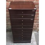 A mahogany music chest of ten drawers, each with typical hinged fronts and brass pulls, raised on