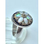An early Victorian opal and diamond setting later converted to a ring, set with six oval opals in