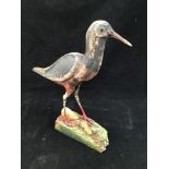 A carved and painted wooden sculpture of an Oystercatcher With glass eyes, raised on naturalistic