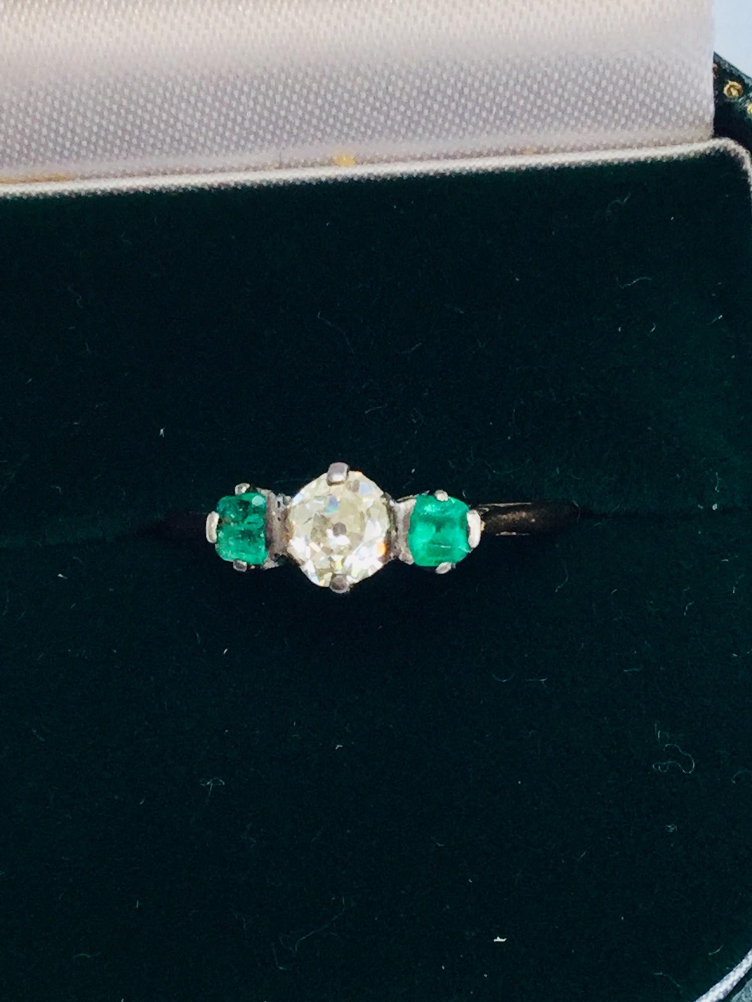 A 14ct yellow gold Emerald and Diamond dress ring in a wave claw set design. Set with 14 x round