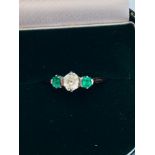A 14ct yellow gold Emerald and Diamond dress ring in a wave claw set design. Set with 14 x round