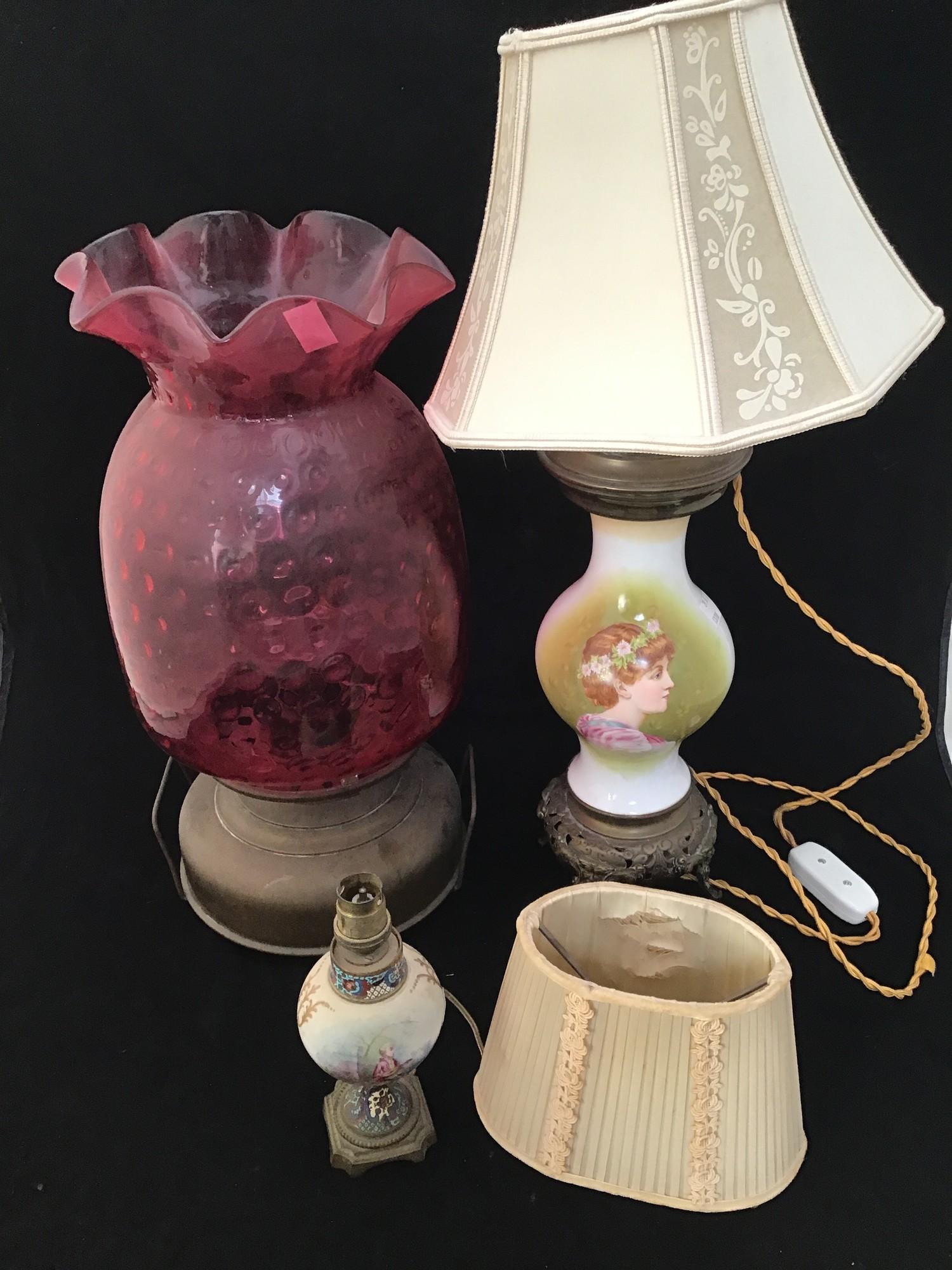 A large cranberry glass pineapple shaped oil lamp, lacking funnel, 49cm high, together with two