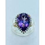 A ladys 9ct gold Amethyst and diamond dress ring. The pear shaped amethyst measures 12mm x 20mm