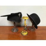 Two various turned wooden wig stands together with a painted wig stand with carved gentleman to