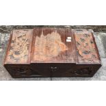 A 20th century oriental carved camphor wood blanket box, the stepped top and front carved with