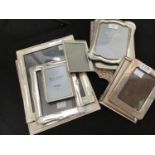 Ten assorted silver-plated photo frames, in varying shapes and sizes, largest measures 31 x 25cm