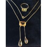 A 9ct gold fine pendant necklace hung with one rectangular and two pear-shaped citrine, together