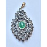 A Victorian emerald and diamond pendant, set with a cabochon emerald to the centre surrounded by