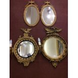 A pair of Neo-Classical oval wall mirrors with bevelled glass, together with two Regency 'style