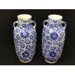 A pair of Chinese blue and white porcelain vases of cylindrical form, each with twin handles and