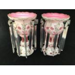 A pair of Victorian pink and white overlay glass lustres, painted with floral scenes, scalloped gilt
