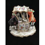 A Continental porcelain figure group of a lady in a sedan chair talking to a finely dressed man with