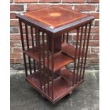 A Reproduction mahogany revolving bookcase, together with a nest of three oval mahogany tables and