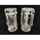 A pair of Victorian clear glass candlestick lustres with ridged rims, each hung with eight Various