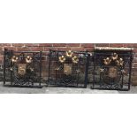 A three-piece wrought iron gate set originally from a church, encrusted with gold painted flowers,