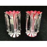 A near pair of Victorian bohemian cranberry and white overlay glass lustres with scalloped rims,