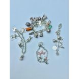 WITHDRAWN: Four assorted silver charm bracelets, consisting of various charms including a telephone