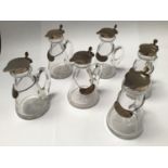 A set of five silver-topped whiskey tots / noggins by Hukin & Heath Ltd, each with silver whiskey