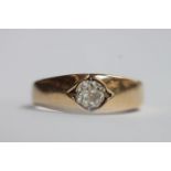A yellow metal (tests as 18ct gold) ring, the top centrally set with a Victorian cut solitaire