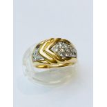 A ladys 18ct (unhallmarked) dress ring, set with 13 x round brilliant cut diamonds. Estimated