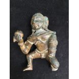An Indian bronze figure of baby Krishna stealing a ball of butter, approx. 12cm long (as found)