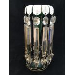 A Victorian emerald green glass lustre with white overlaid trumpet shaped rim painted with gilt