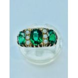 A 9ct yellow gold dress ring, set with 3 x oval green stones and six small round opals. Ring