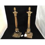 A pair of brass table lamps modelled as Corinthian columns, raised on stepped, square base, 56cm