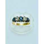 An 18ct gold (no hallmark) Sapphire and diamond ring, set with 3 x round sapphires and 2 x round