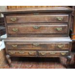 An early 18th century oak Mule chest-on-stand, upper coffer section with fielded panel hinged top,