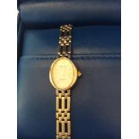 A ladies 9ct gold Rotary wristwatch, oval white enamel dial, quartz movement and 9ct gold gate-