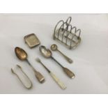 A small collection of assorted silver items comprising a four-division toast rack, hallmarked