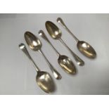 Five assorted Georgian silver 'Old English' pattern table spoons including one by Richard