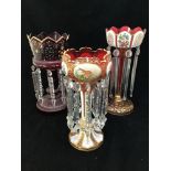 Three various Victorian glass lustres including a cranberry glass and white overlaid lustre with