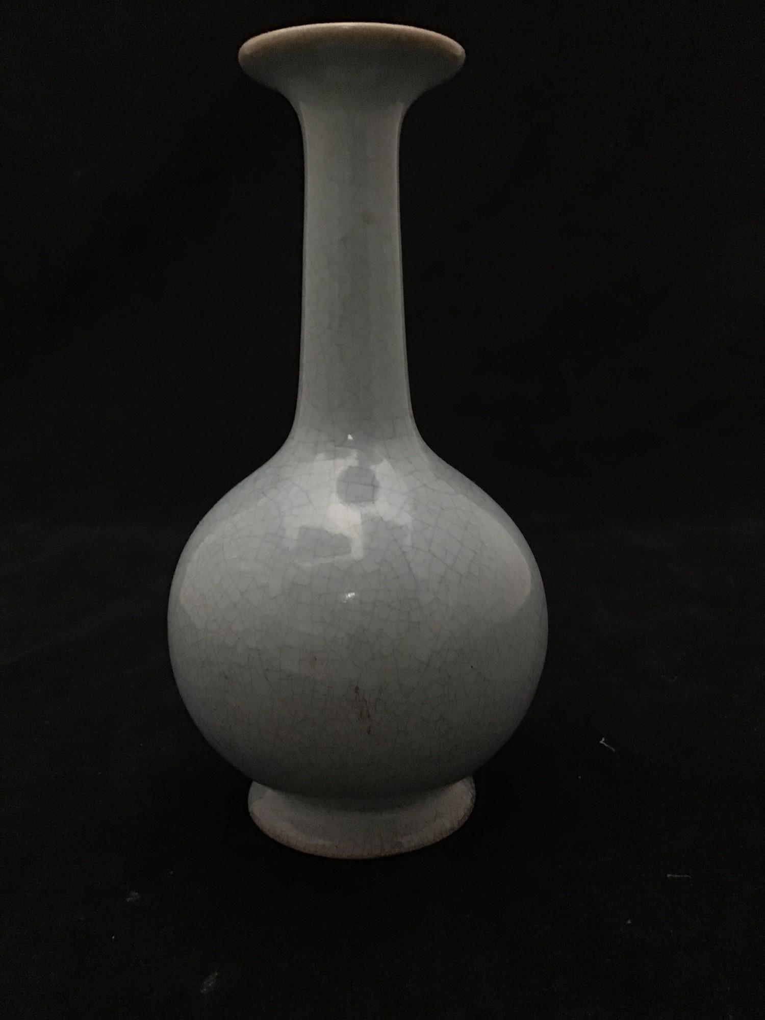A Chinese celadon crackle-glazed vase, of shaft and globe form, 19 cm tall