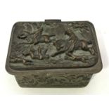 A white metal casket, the hinged cover depicting a scene of gamekeepers catching a poacher, cast and