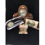 Five various clocks including an onyx clock, of temple form with Corinthian columns, cream enamel