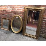 A large rectangular mirror together with an oval gilt mirror and smaller rectangular mirror with