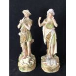 A pair of Royal Dux Bohemia figures modelled as a shepherd playing a pipe with a sheep at his feet