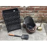 A copper coal scuttle together with a black wrought iron umbrella / stick stand and a loaded brass