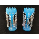 A pair of Victorian blue glass lustres with lotus leaf shaped rims, etched with floral scenes and