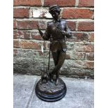 A bronze figural sculpture of an Aesthete/Dandy with a flower and sword, walking a dog, raised on