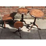 Two 19th century stained mahogany tripod tables and a reproduction tripod table, together with a