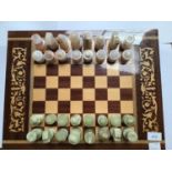 A Sorrento ware marquetry chessboard, with hinged top and compartmented interior with a set of