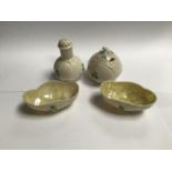 Four pieces of Belleek pottery comprising a lidded pot, two oval dishes and a pepper pot etc.