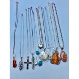 An assorted lot of silver jewellery, consisting of 13 various pendants and chains. including amber