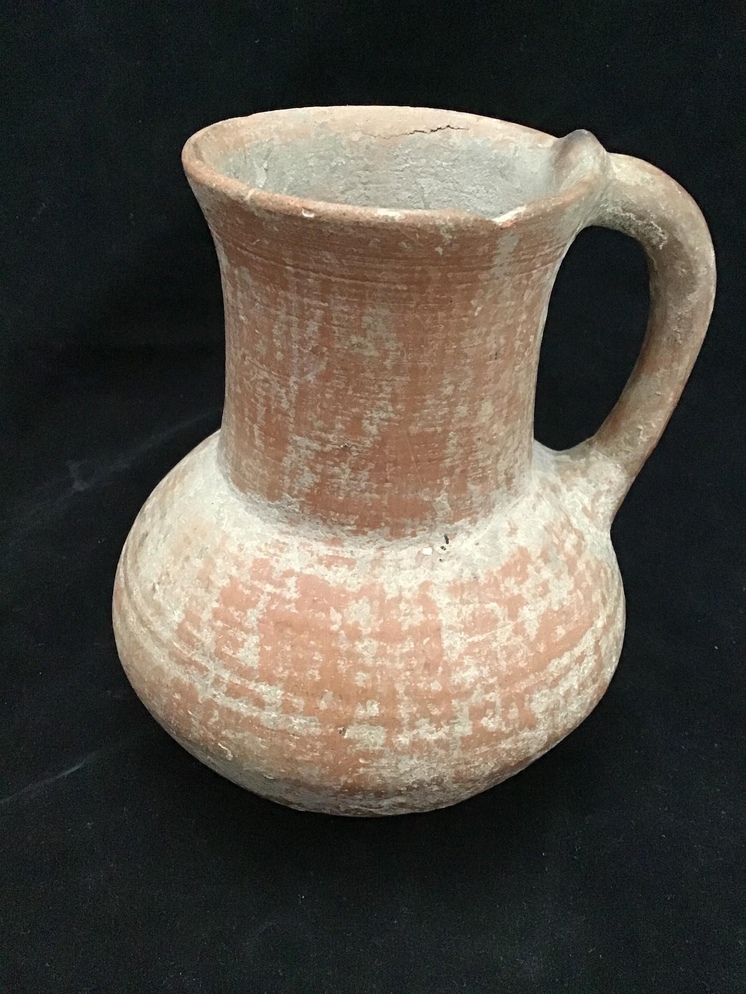 A Roman pottery carafe / jug, bought in 1972 in modern day Iran, 16cm high, with original receipt