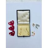 An assorted lot of 9ct gold earrings. Including a pair of drop seed pearl earrings and a pair of